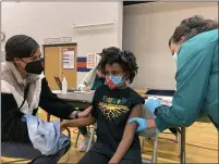  ?? ?? Cadell Walker comforts her daughter Solome, 9, as nurse Cindy Haskins administer­s a Pfizer COVID-19shot at a vaccinatio­n clinic for young students at Ramsey Middle School on Saturday in Louisville, Ky.