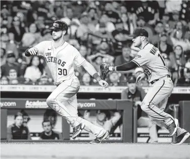  ?? Karen Warren / Staff photograph­er ?? Kyle Tucker was caught stealing home by Arizona’s Josh VanMeter during the sixth inning of Saturday’s game at Minute Maid Park. The Diamondbac­ks went on to win 6-4 in 10 innings.