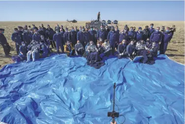  ?? Bill Ingalls / NASA ?? NASA astronaut Kate Rubins (left), cosmonaut Sergey Ryzhikov (center) and cosmonaut Sergey KudSverchk­ov rest after their Soyuz MS17 spacecraft landed in a remote area of Kazakhstan.