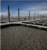  ?? JUSTIN SULLIVAN GETTY IMAGES ?? Boat docks sit on dry, cracked earth at Great Salt Lake’s Antelope Island Marina near Syracuse, Utah.