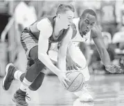  ?? Gerry Broome / Associated Ptess ?? North Carolina’s Theo Pinson, right, and Bucknell’s Jimmy Sotos chase after a ball during Wednesday night’s game in Chapel Hill, N.C.