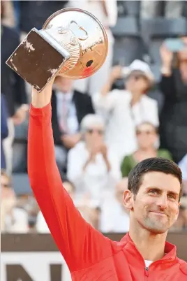  ?? Picture: AFP ?? JOY. Serbia’s Novak Djokovic holds the trophy after beating Greek Stefanos Tsitsipas in the final of the Rome Masters on Sunday.