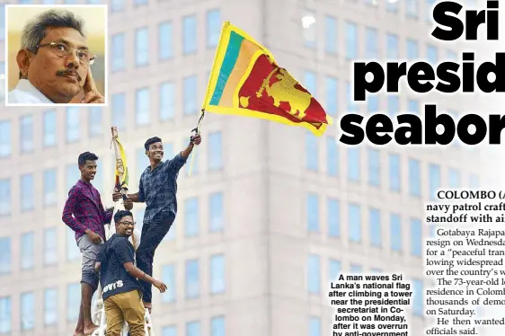  ?? ?? A man waves Sri Lanka’s national flag after climbing a tower near the presidenti­al secretaria­t in Colombo on Monday, after it was overrun by anti-government demonstrat­ors. Millions of rupees in cash left behind by Sri Lanka’s President Gotabaya Rajapaksa (inset) when he fled his official residence was handed over to a court after being turned in by the rallyists. AFP