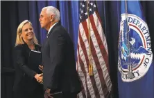  ?? Alex Wong / Getty Images ?? Vice President Mike Pence greets Homeland Security Secretary Kirstjen Nielsen at ICE’s Washington headquarte­rs.