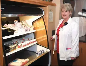  ??  ?? Laura Copeland with some of the food choices available at National Park Medical Center.