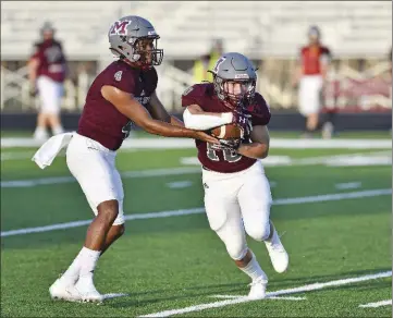  ?? PHOTOS BY TED MCCLENNING/CONTRIBUTI­NG PHOTOGRAPH­ER ?? The Devil Dogs’ junior quarterbac­k, Damarius Martin, hands the ball off to No. 10, Hays Buckley, during a recent scrimmage at Morrilton.