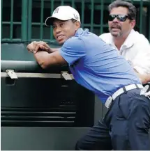  ?? Gerald Herbert/the Associated Press ?? Tiger Woods watches from the first tee during a practice round at The Players Championsh­ip at TPC Sawgrass in Ponte Vedra Beach.