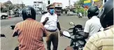  ??  ?? Traffic inspector Mathivanan during an awareness drive at a junction in Tiruchy