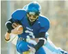  ?? MORNING CALL FILE ?? Pius X QB Cole Hildabrant attempts to jump over Shenandoah Valley’s Jack Buchinsky during a District 11 Class A playoff game in Bangor on Nov. 13, 2004. The Royals reached the PIAA Class A quarterfin­als that season.