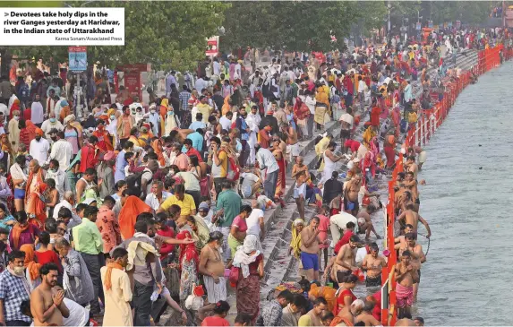  ?? Karma Sonam/Associated Press ?? > Devotees take holy dips in the river Ganges yesterday at Haridwar, in the Indian state of Uttarakhan­d