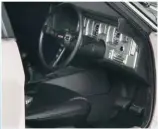  ??  ?? Detailed interior featuring full dash instrument­ation, badged steering wheel and fabric seat belts.