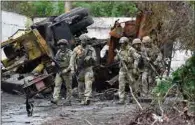  ?? (AFP) ?? Russian servicemen patrol the destroyed part of the Ilyich Iron and Steel Works in Ukraine’s port city of Mariupol on Wednesday.