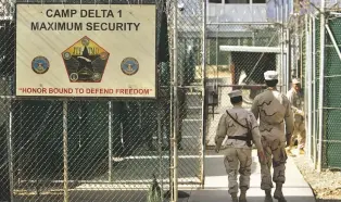  ?? ASSOCIATED PRESS FILE PHOTO ?? In June 2016, U.S. military guards walk within Camp Delta — a military-run prison at the Guantánamo Bay U.S. Naval Base, Cuba. Attorney General Jeff Sessions visited Guantánamo Bay on Friday in a show of support for the prison.