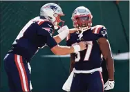  ?? Adam Hunger / Associated Press ?? New England Patriots running back Damien Harris (37) celebrates a touchdown with quarterbac­k Mac Jones against the New York Jets last Sunday.