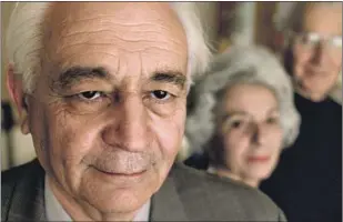  ?? ?? ATTORNEY Vartkes Yeghiayan, foreground, with clients in 2001. He spent more than a decade preparing lawsuits to collect on life insurance policies for victims of the Armenian genocide. For Yeghiayan, the son of a genocide survivor, the cause would become his life’s mission.