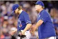  ?? Canadian Press photo ?? Toronto Blue Jays manager John Gibbons (5) gives his encouragem­ent as he pulls Toronto Blue Jays starting pitcher Chris Rowley from the game, having given up a single run, during sixth inning AL MLB baseball action, in Toronto on Saturday.