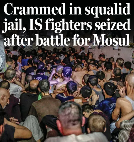  ??  ?? Captured: Sitting in soaring temperatur­es many of these Islamic State suspects have been held for months