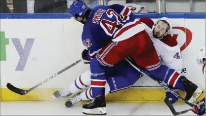  ?? FRANK FRANKLIN II, THE ASSOCIATED PRESS ?? Rangers’ Brendan Smith checks Montreal Canadiens’ Paul Byron during the third period Tuesday in New York. The Rangers won, 2-1.