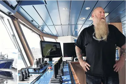  ?? PHOTOS: PETER MCINTOSH ?? First call . . . The captain of Sealord’s vessel Tokatu, Rex Chapman, at the trawl gear controls on the ship’s bridge yesterday. The ship was docked at the Fryatt St wharf.