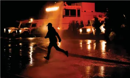  ??  ?? Police use water cannon during protests in Belfast, Northern Ireland, 8 April 2021. Photograph: Jason Cairnduff/Reuters