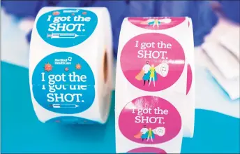  ?? JOSEPH PREZIOSO / AFP via Getty Images ?? Stickers for the clergy to wear after they receive the vaccine sit on a table at Hartford HealthCare St. Vincent’s Medical Center in Bridgeport on Feb. 26, 2021.