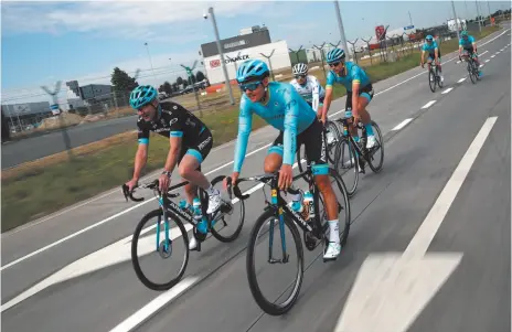  ?? AP PHOTO BY CHRISTOPHE ENA ?? Denmark’s Jakob Fuglsang, foreground, rides with teammates during a training session in Brussels on Friday, ahead of Saturday’s start of the race.