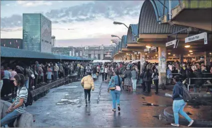  ??  ?? Stranded: Commuters queue at the Cape Town taxi rank as the nationwide bus drivers’ strike drags on, with no end in sight to the wage impasse. Photo: David Harrison