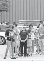  ?? GERALD HERBERT/ AP ?? People line up at Costco to buy provisions in New Orleans on Sunday before Hurricane Marco, expected to make landfall Monday.