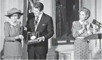  ?? JOSE R. LOPEZ/NEW YORK TIMES ?? First lady Nancy Reagan, right, applauds as President Ronald Reagan presents Brooke Astor with a National Medal of Arts in 1988 at the White House. President Donald Trump is the first president to go so long without awarding national medals in the arts and humanities.