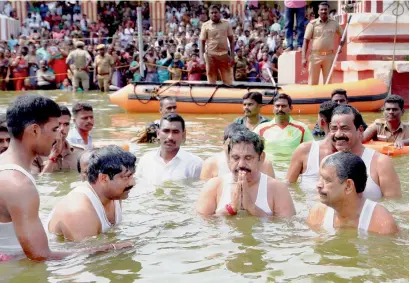  ?? PTI ?? Tamil Nadu Chief Minister K Palaniswam­i with state handloom minister O S Manian, chief government whip S Rajendran and others taking holy dip in the Cauvery river, during the ongoing Cauvery Pushkarani festival, in Tamil Nadu on Wednesday. —