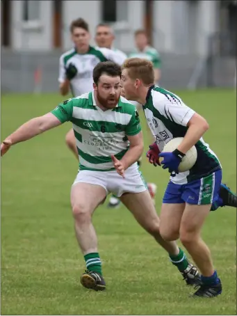  ??  ?? Kevin Byrne looks to put a stop to AGB’s Darragh Fitzgerald’s gallop during the IFC in Aughrim.