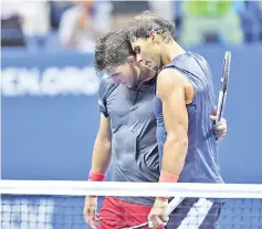  ??  ?? Spain’s Rafael Nadal embraces Austria’s Dominic Thiem after winning their quarter-final match. — AFP photo
