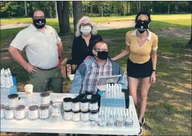  ?? COURTESY DUTTON FARM ?? EveryBody by Dutton Farm makes and sells products like candles, soaps, lip balms and hand sanitizer and employs those with developmen­tal disabiliti­es. Co-founder Jenny Brown (far right) is pictured with some of the employees.