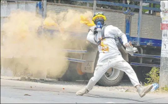  ?? The Associated Press ?? An anti-coup demonstrat­or throws a smoke bomb against the police crackdown Saturday in Yangon, Myanmar.