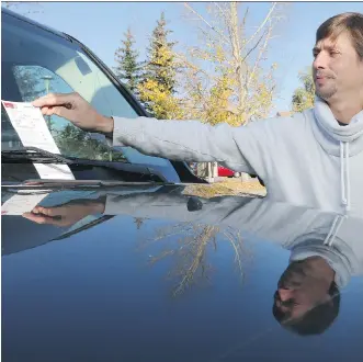  ?? FILES ?? Martin Moreet and his neighbours woke up on Oct. 6 to find parking tickets on their vehicles parked around the cul-de-sac of Woodmont Green S.W. They were fined for angle parking instead of parallel parking.