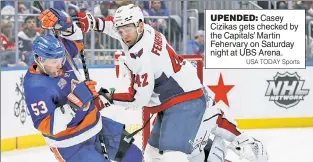  ?? USA TODAY Sports ?? UPENDED: Casey Cizikas gets checked by the Capitals’ Martin Fehervary on Saturday night at UBS Arena.