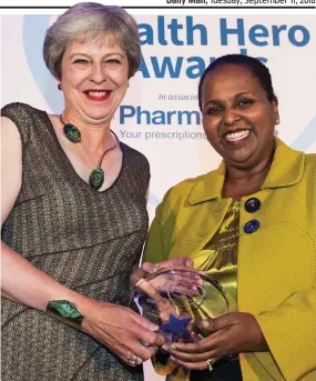  ??  ?? Winner: Theresa May gives Sohier Elneil her award last night