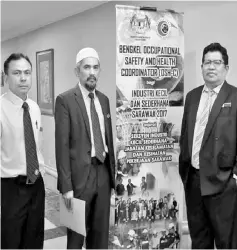  ??  ?? (From left) Mut, Mohd Hatta and Ahmad Fauzi pose for the camera during a break at the OSH-C workshop in Kuching.