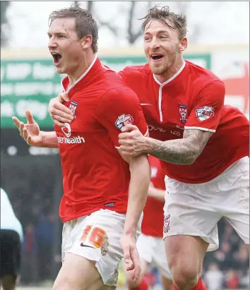  ??  ?? CHEST GREAT: Jake Hyde grabs team-mate Dave Winfield in celebratio­n of the defender’s goal