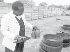  ??  ?? National Council of Disabled Persons of Zimbabwe, Bulawayo branch Co-ordinator, Mrs Caroline Moyo (left) admires sandals made by people with disabiliti­es in Bulawayo last week