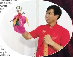  ??  ?? Zhu Xueshan uses his deft hand to manipulate one of his puppets. — Zhu Ying