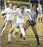  ?? ROD THORNBURG / FOR THE CALIFORNIA­N ?? ABOVE: Liberty’s Justyce Amey, right, struggles to kick the ball between the legs of Clovis North’s Sommer Nestman (24).
LEFT: Liberty’s Hayden Gehring, right, battles against Clovis North’s Addison Posey.