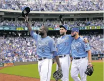  ?? CHARLIE RIEDEL/ASSOCIATED PRESS FILE PHOTO ?? From left, Royals players Lorenzo Cain, Eric Hosmer and Mike Moustakas aknowledge the crowd last month as they come out of a game in Kansas City, Mo. The trio were among nine free agents who have received $17.4 million qualifying offers Monday from...
