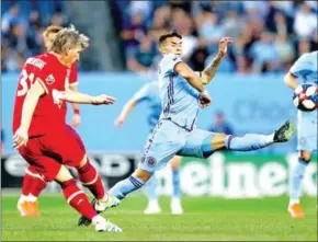  ?? ELSA/GETTY IMAGES/AFP ?? Valentin Castellano­s of New York City FC attempts to block a pass from Bastian Schweinste­iger of Chicago Fire at Yankee Stadium on April 24.