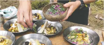  ?? ANDREA SACHS/THE WASHINGTON POST ?? Asa Herrgard chef Pontus Sjoholm sprinkles fresh herbs on his dish.