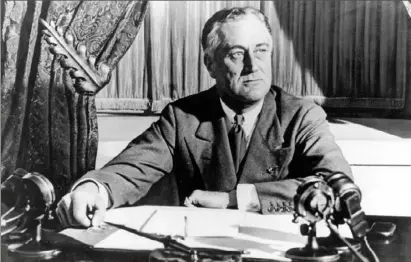  ?? Associated Press ?? President Franklin D. Roosevelt delivers his first radio “fireside chat” in Washington in March 1933.