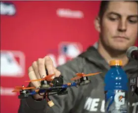  ?? THE ASSOCIATED PRESS FILE ?? In this Oct. 16, 2016, file photo, Indians pitcher Trevor Bauer holds a drone that caused an injury to his finger during a news conference in Toronto. Bauer says the drone incident is behind him now and he has to take the mound and perform.