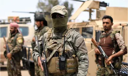  ??  ?? FIGHTERS OF the Syrian Democratic Forces are seen in Deir al-Zor yesterday.