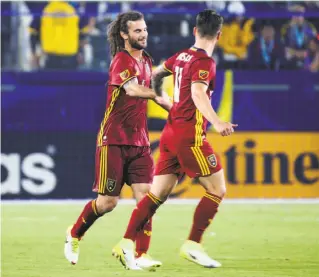  ?? Reed Saxon / Associated Press ?? Real Salt Lake’s Kyle Beckerman (left) and Albert Rusnak celebrate Beckerman’s goal during a 6-2 beatdown of the L.A. Galaxy at the StubHub Center in Los Angeles County.