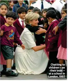  ??  ?? Chatting to children – on their level – at a school in London, 1997